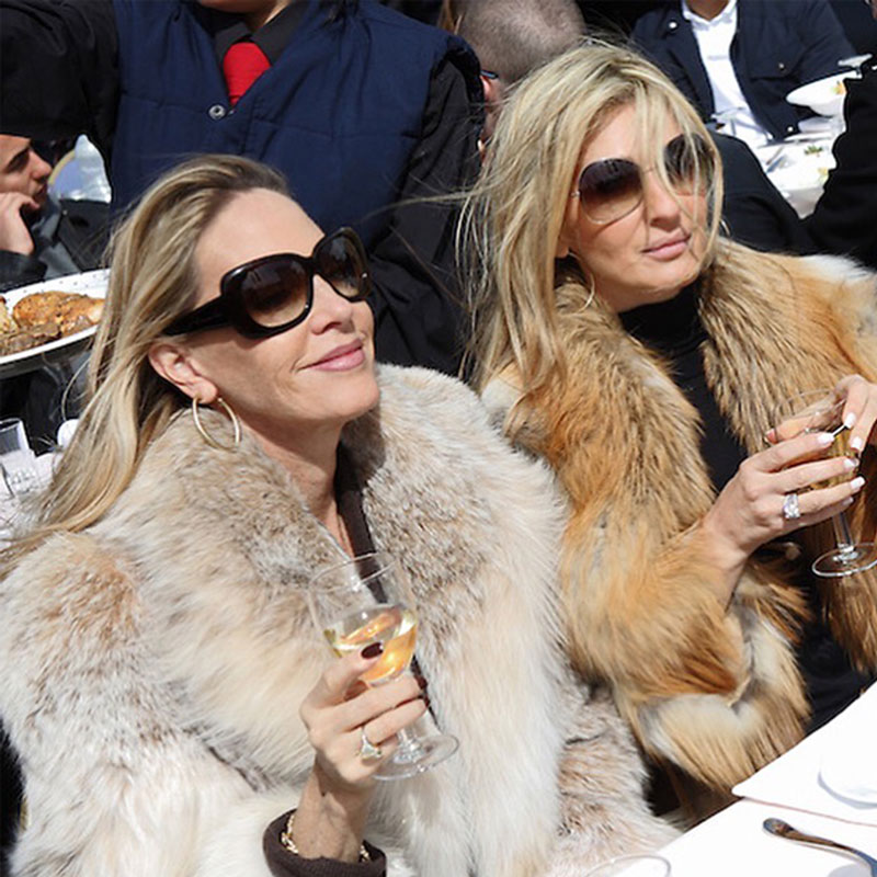 Debra enjoying champagne with sister wearing fur coats