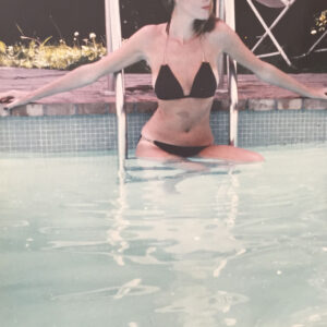 Debra Vallentyne modeling in a black bikini in a pool