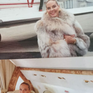 Debra in fur coat with private airplane