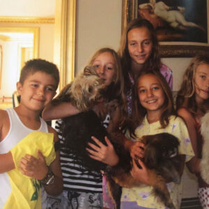 Five of Debra Vallentyne's kids holding pet dogs